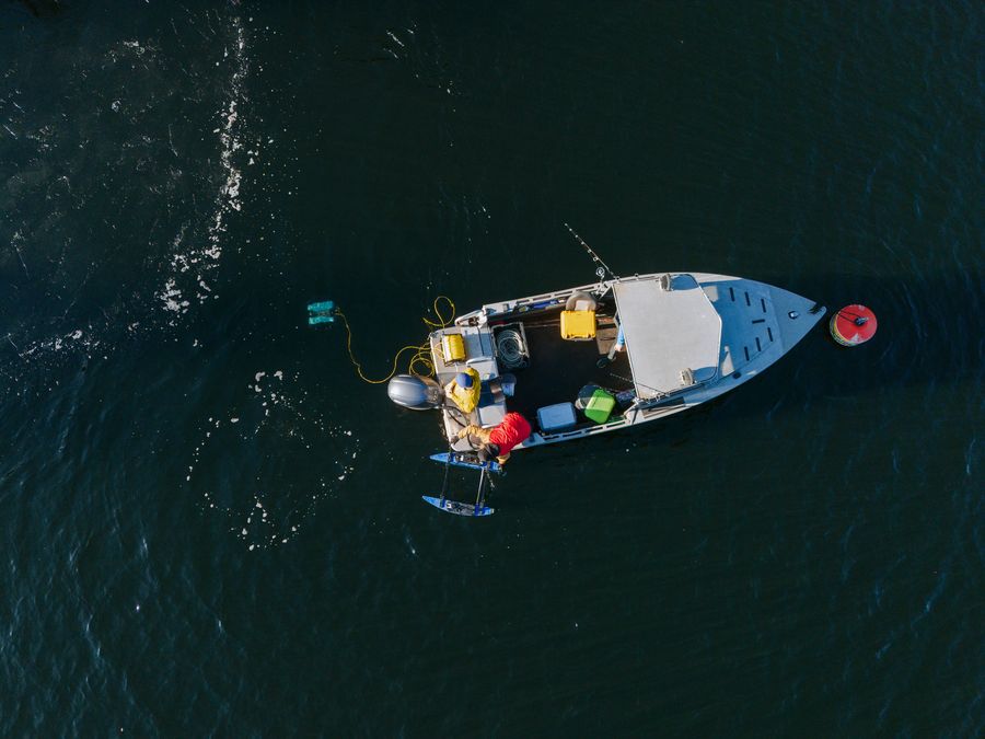 Aerial view of a boat deploying an ROV in dark water